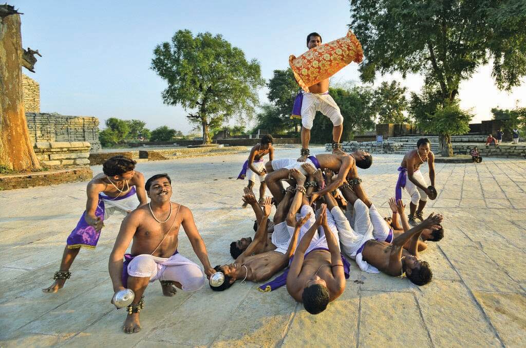 Panthi Dance Performance on stage with human pyramid